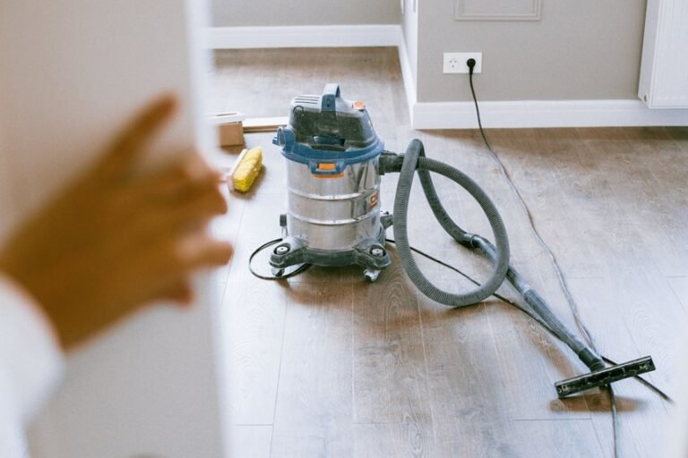 vacuuming dust from baseboards